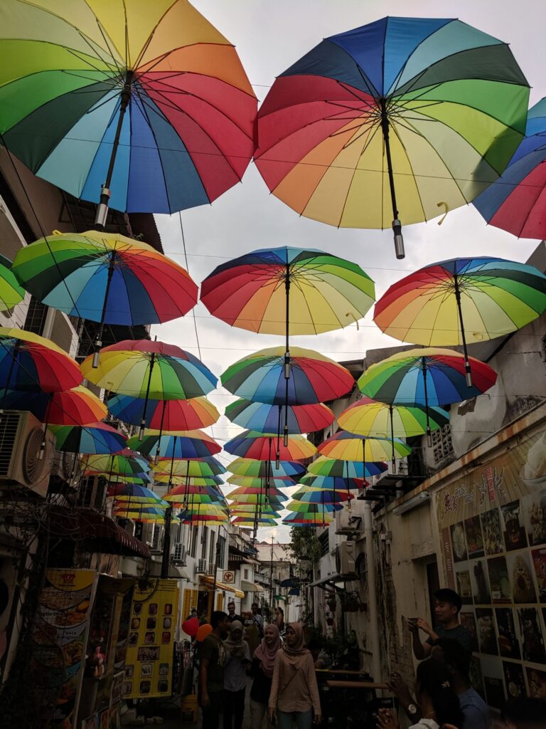 colourful umbrellas hanging at roof level creating a cover over a walkway