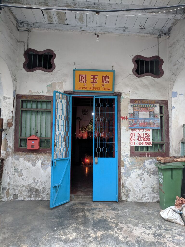 A shop front with an open blue door in Malaysia