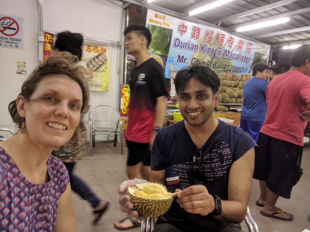 Friends at a market about to eat durian
