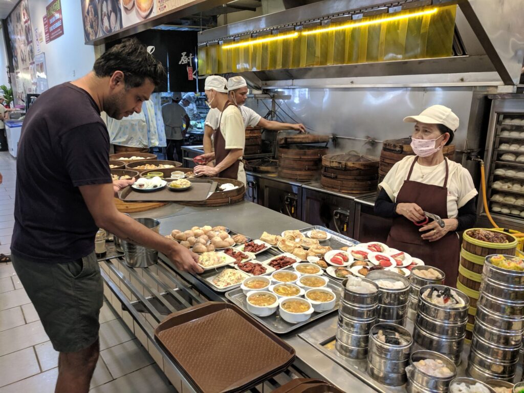 A man choosing food from a large kitchen