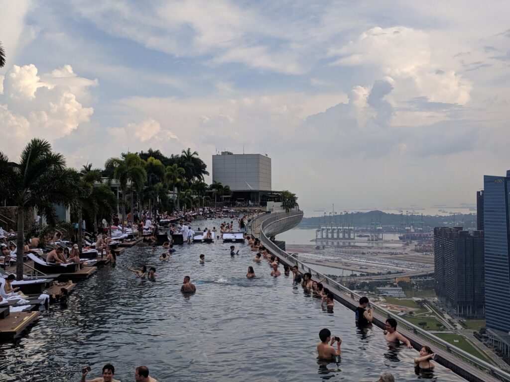 people in a pool on a rooftop of a tall building