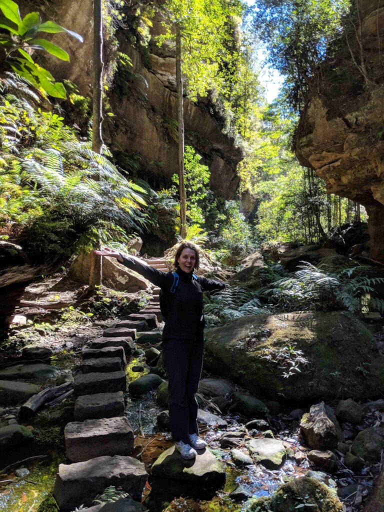 Woman bushwalking through a lush canyon