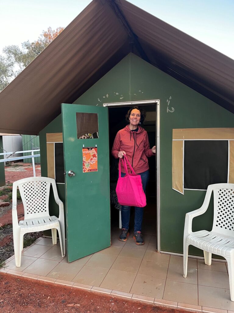 A woman walking out of a tent structure