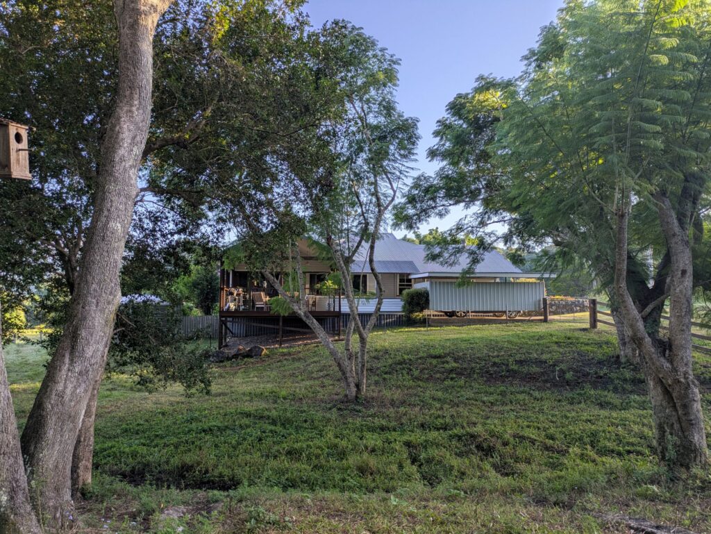 A farm house surrounded by trees