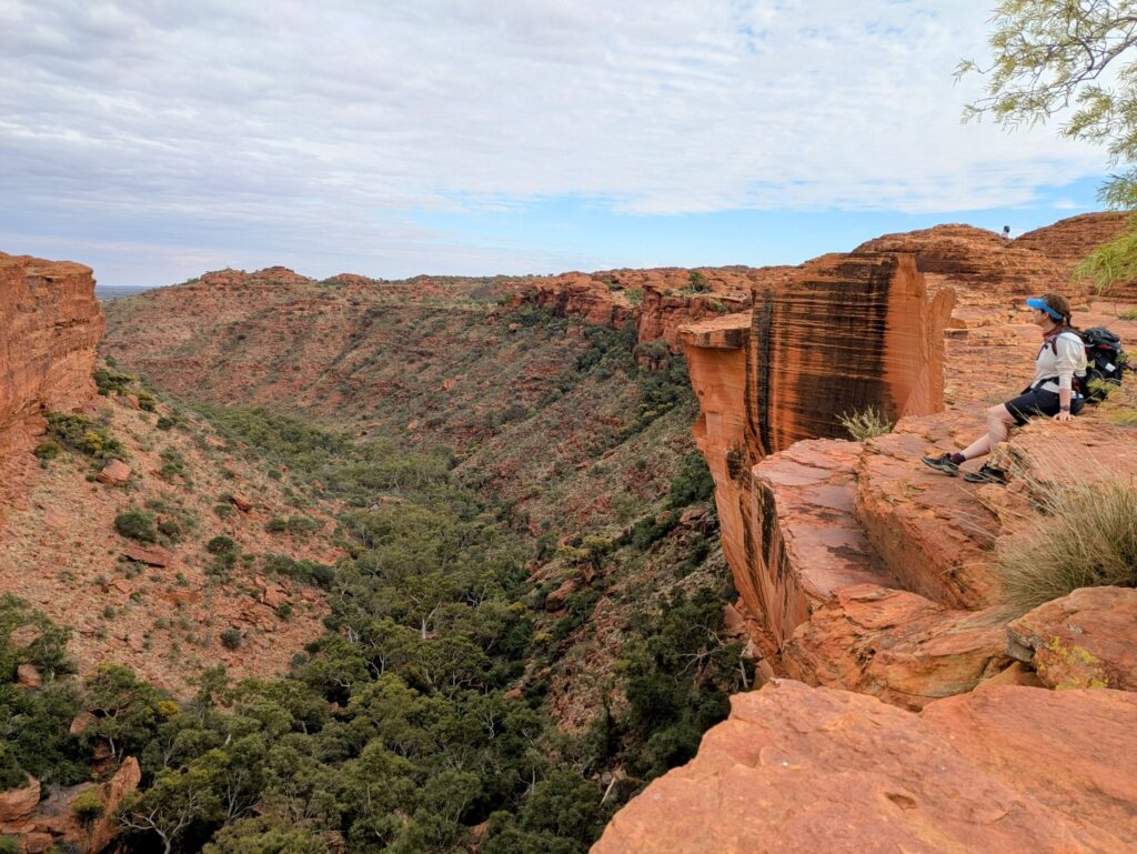 A woman sitting on the edge of canyon