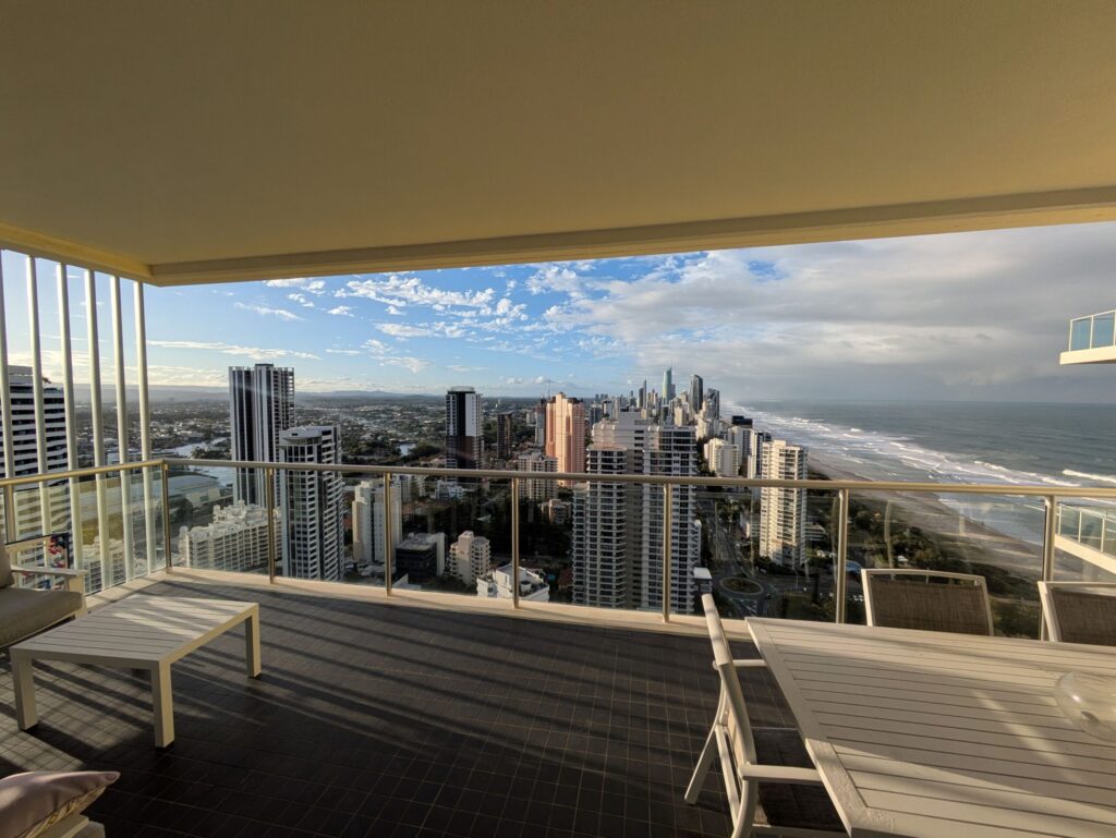 A view of tall skyscrapers by a beach
