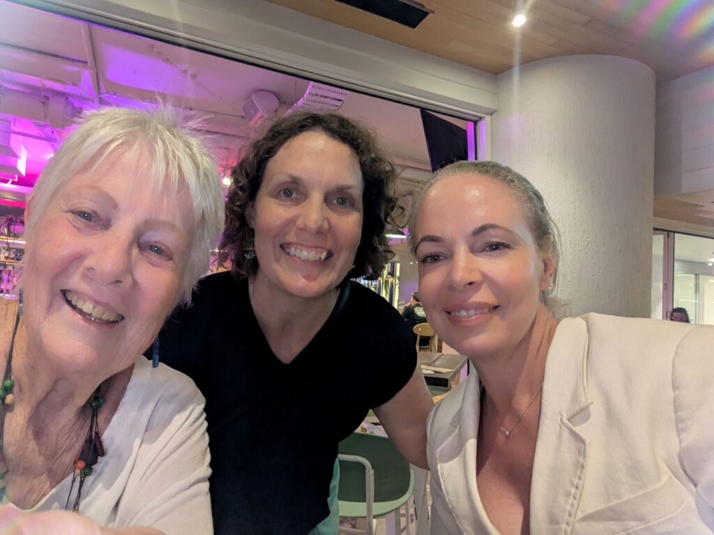 Three women smiling at the camera