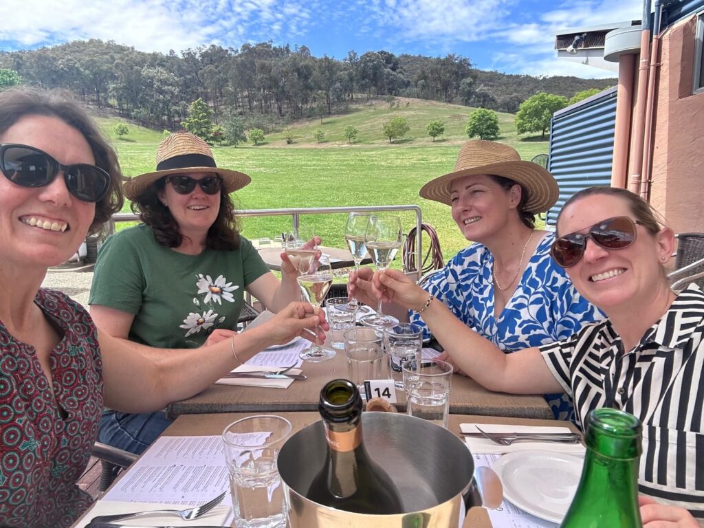 Four friends enjoying lunch at a winery