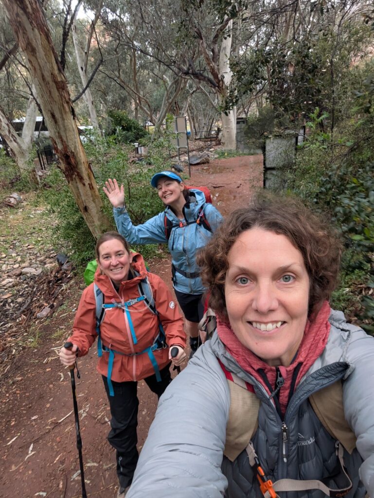 A selfie of 3 women setting out on a hike