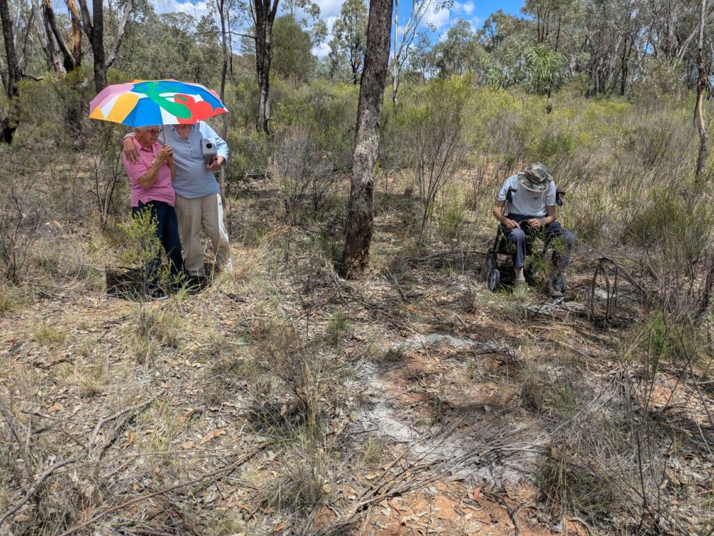 Three people in the bush on a hot summer's day reflecting on life