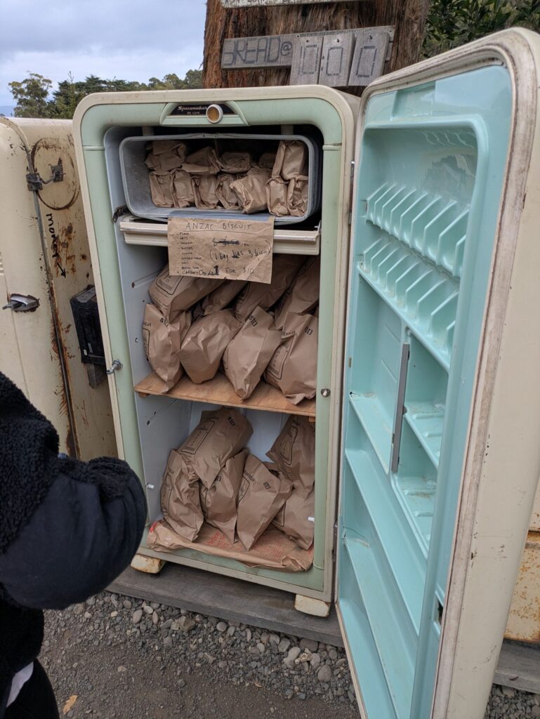 Paper bags filled with fresh loaves of bread inside an old refrigerator