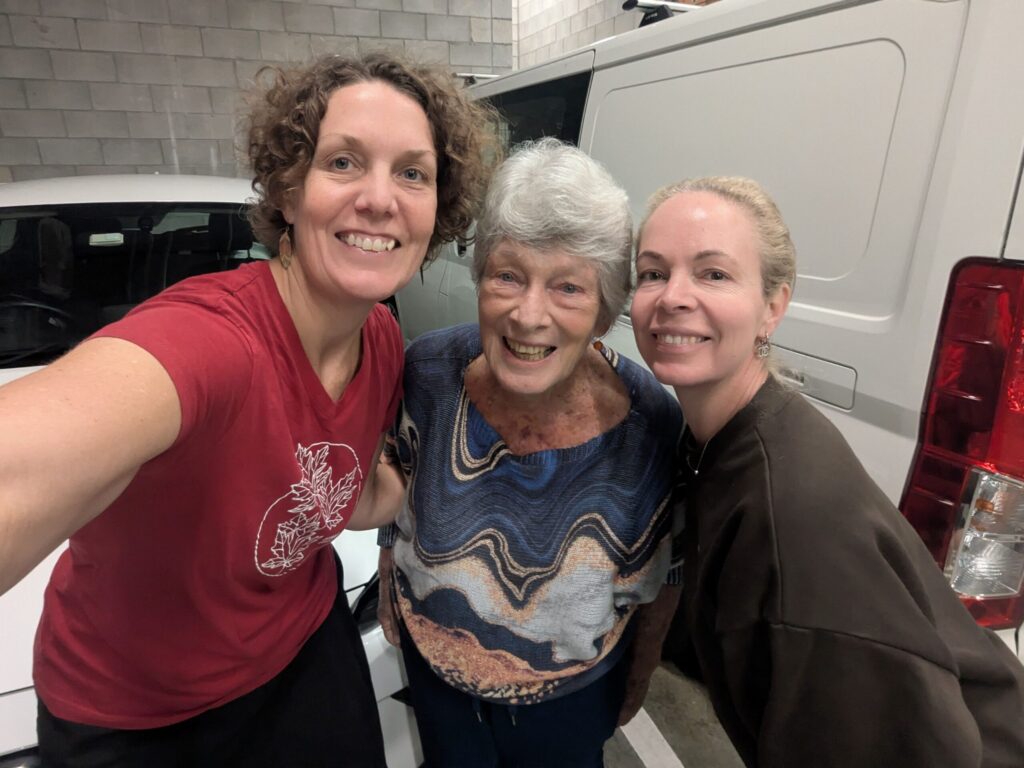 An elderly aunt posing with her two nieces